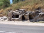 Iron Age rolling stone tomb - Note - the side two openings were made when road construction cut back the bedrock revealing the two body recepticles